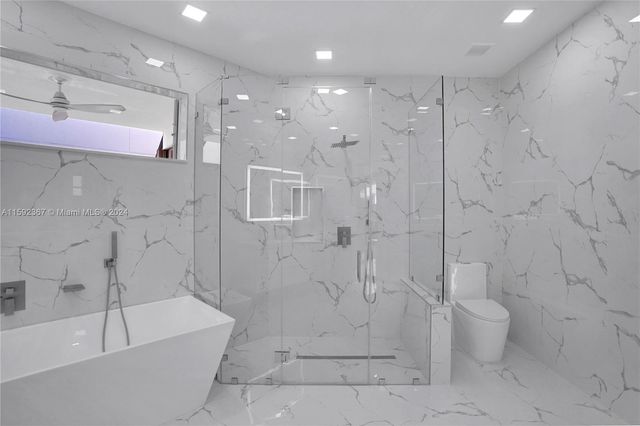 a bathroom with a bathtub and shower