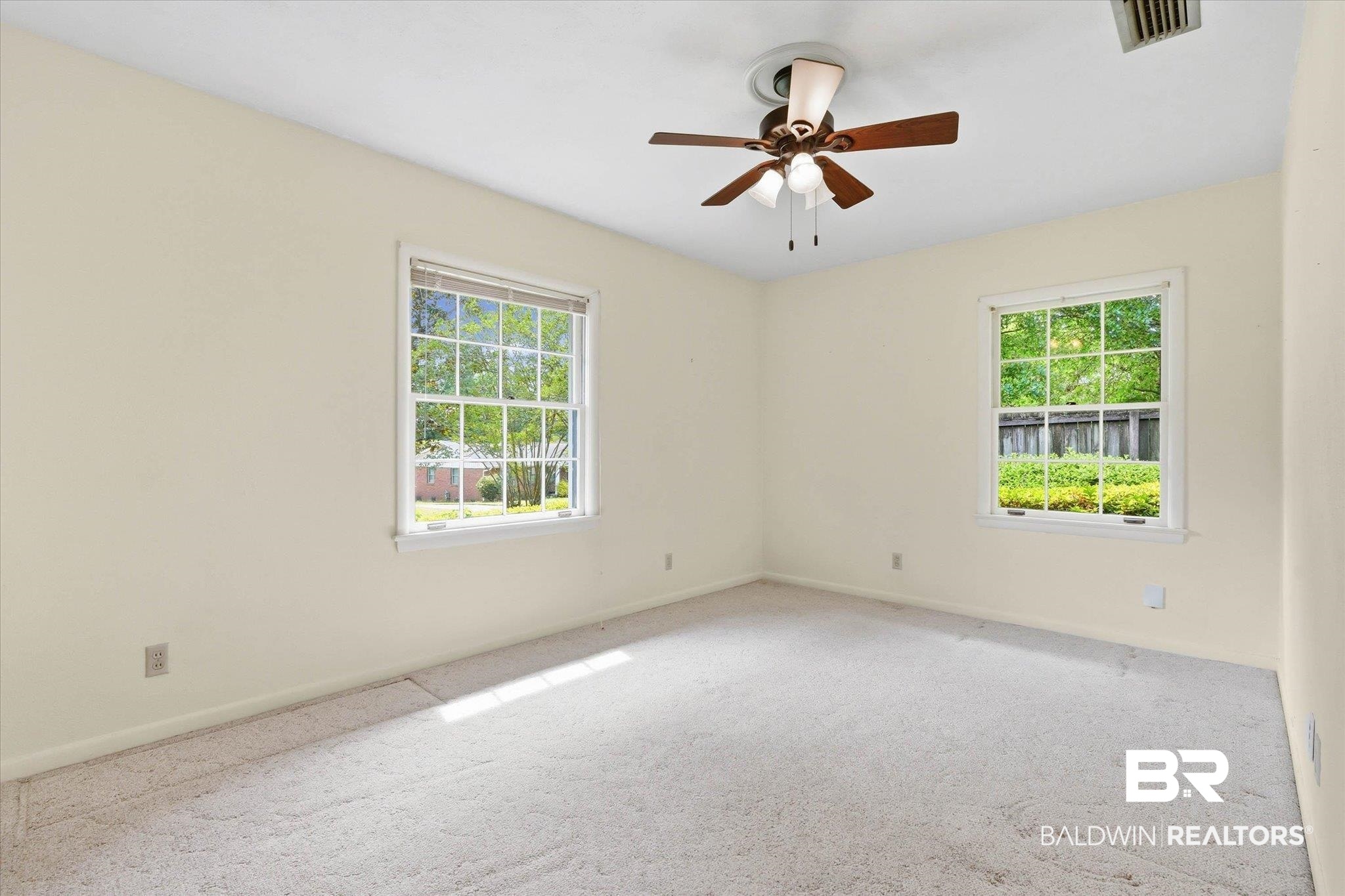 1182 Ginger Drive Mobile, AL 36693 - Photo 21 of 37 Carpeted room featuring two large windows, a ceiling fan with light fixture, and neutral painted walls