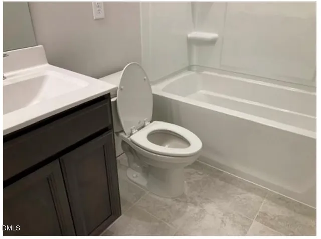 a bathroom with a toilet and a bathtub