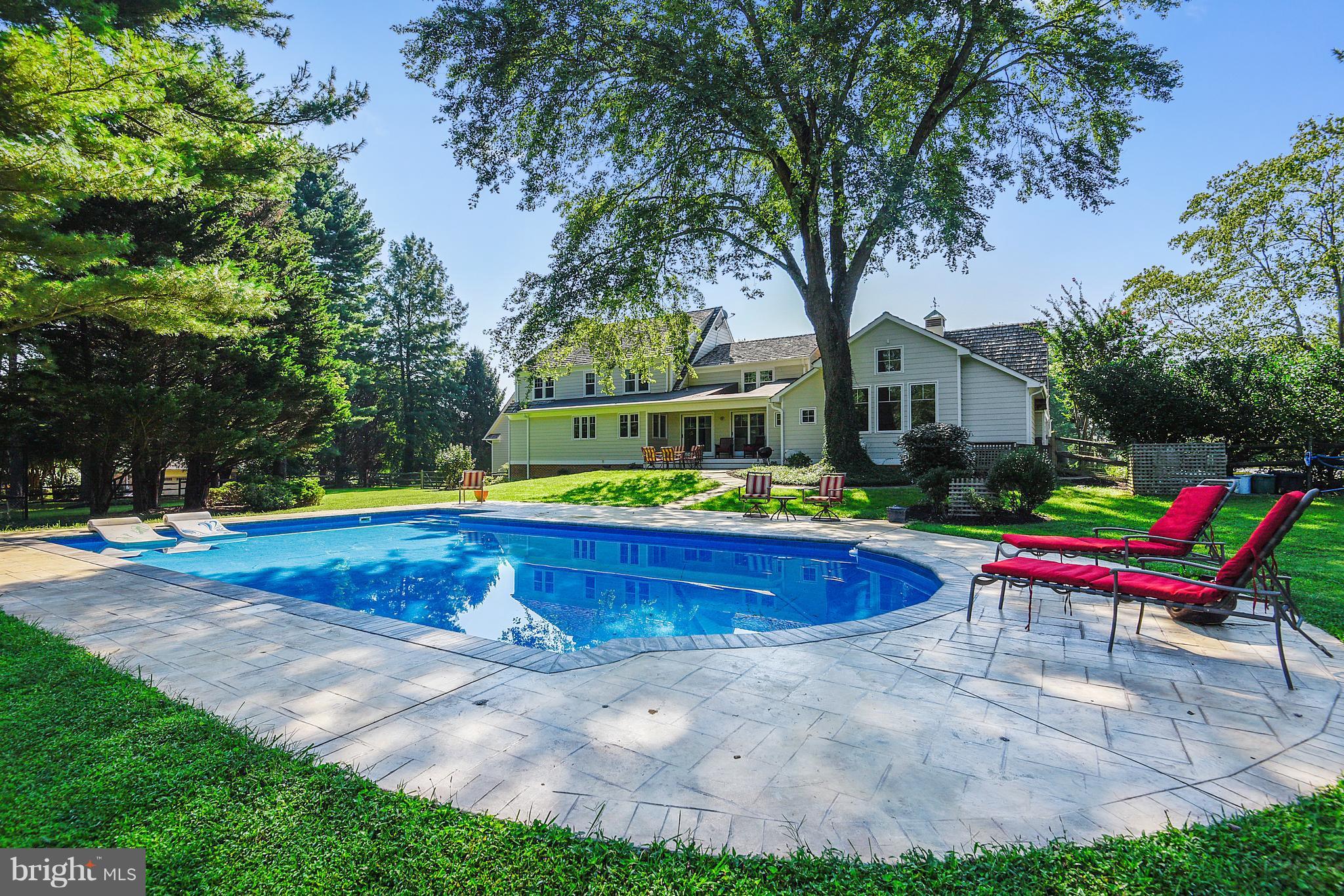 12408 Beall Spring Road Potomac, MD 20854 - Photo 25 of 30 a swimming pool with outdoor seating and yard