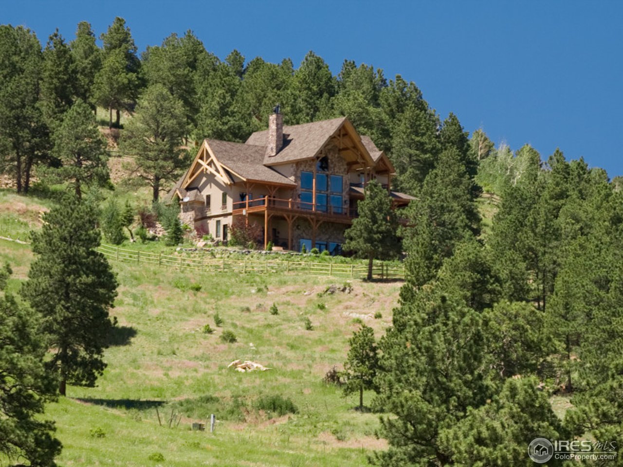 7654 Spirit Ranch Road Golden, CO 80403 - Photo 21 of 25 a front view of a house with a yard