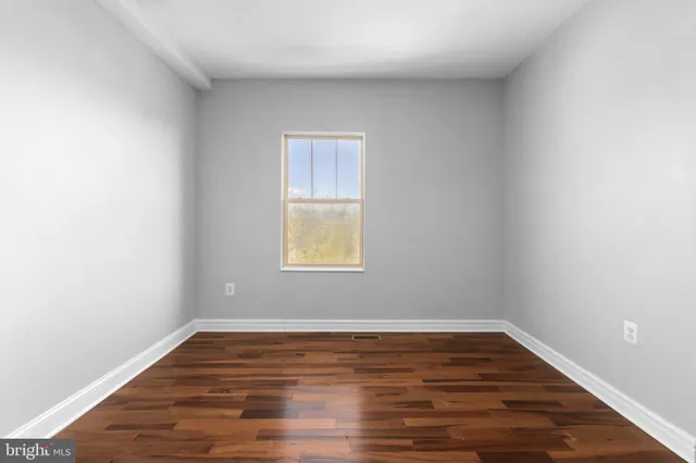a view of wooden floor and windows in a room