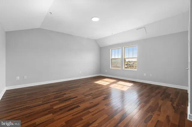 a view of an empty room and wooden floor