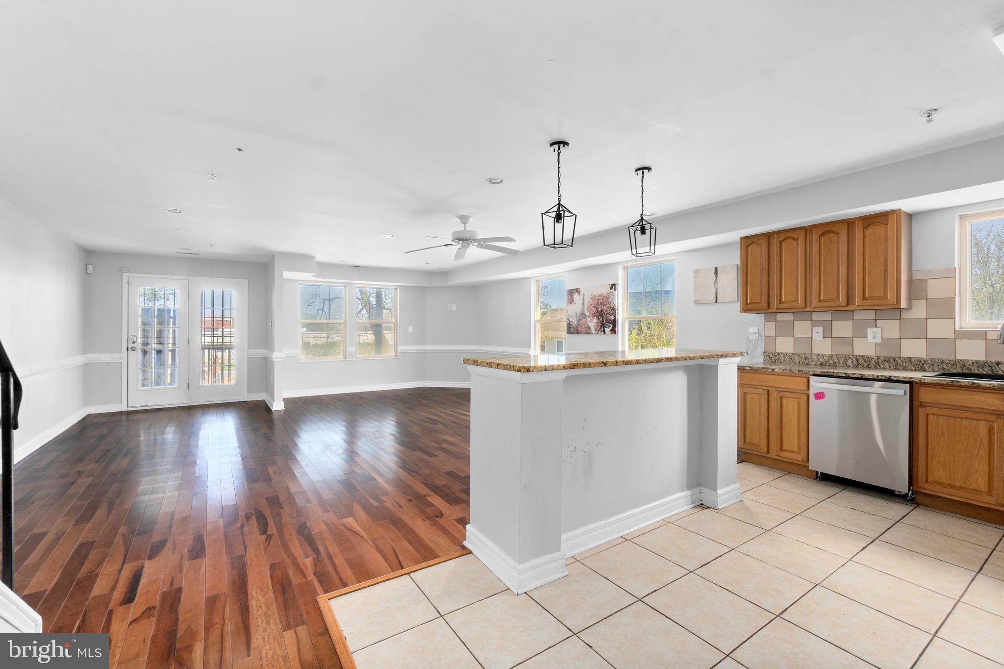 1829 Providence Street Northeast, Unit A Washington, DC 20002 - Photo 6 of 38 a kitchen with stainless steel appliances granite countertop a sink cabinets and wooden floor