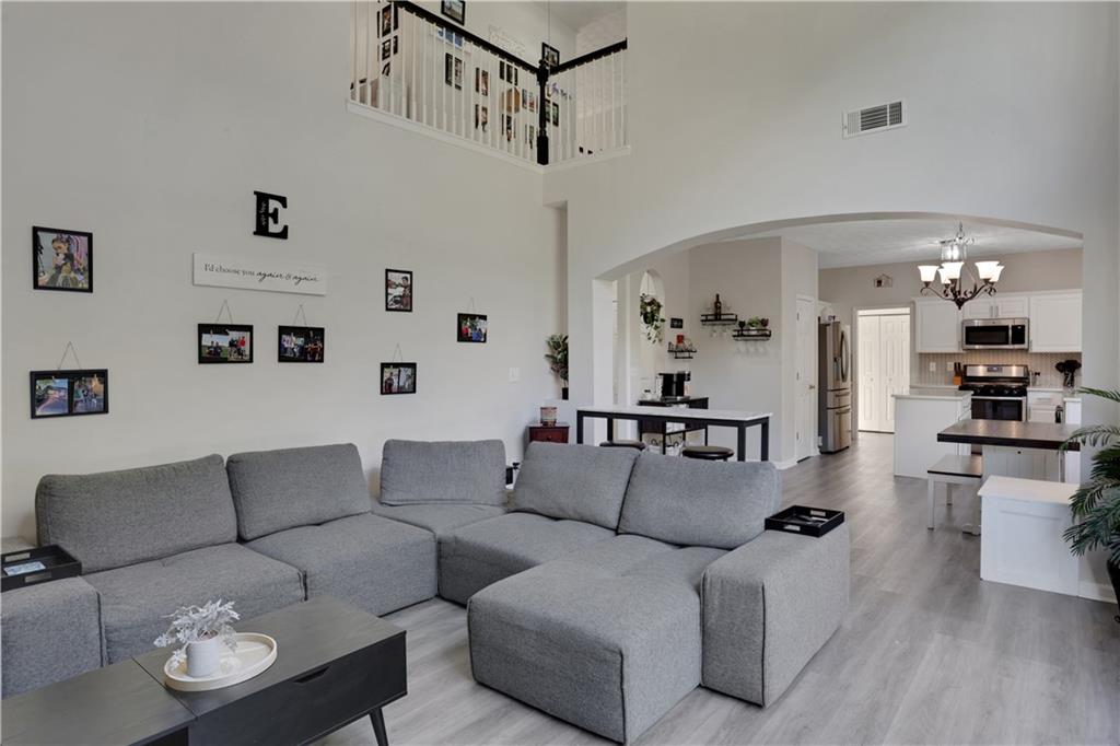 2760 Jona Trail Dacula, GA 30019 - Photo 11 of 40 a living room with furniture kitchen view and a chandelier