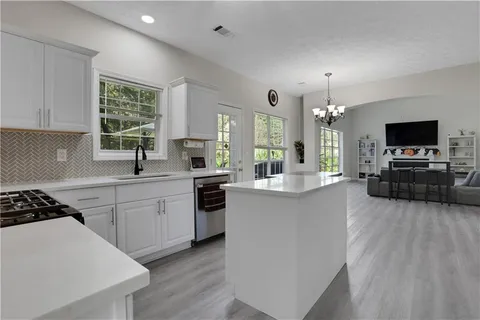 a kitchen with furniture a large counter and appliances