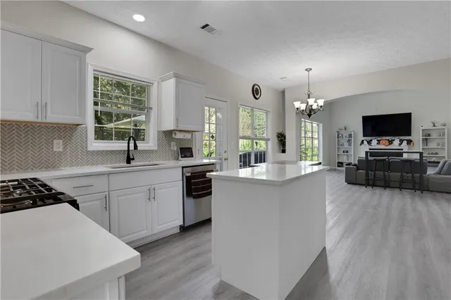 a kitchen with furniture a large counter and appliances