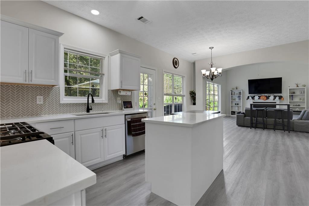 2760 Jona Trail Dacula, GA 30019 - Photo 18 of 40 a kitchen with furniture a large counter and appliances