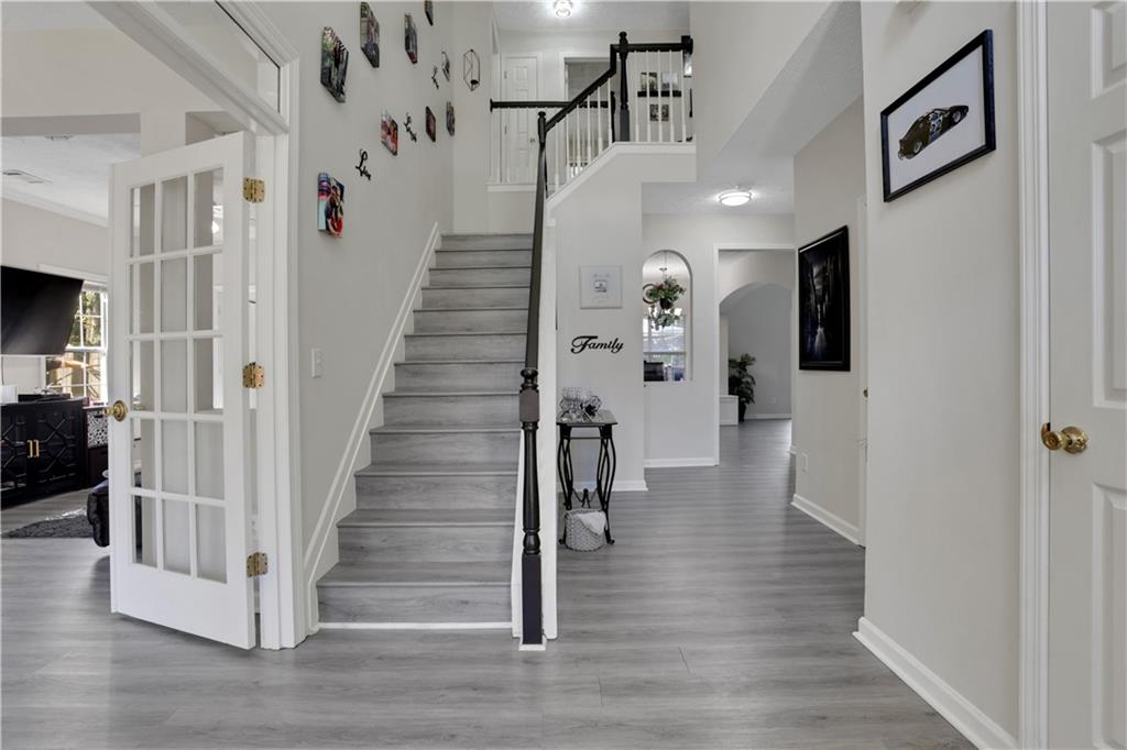 2760 Jona Trail Dacula, GA 30019 - Photo 2 of 40 a view of entryway with furniture and wooden floor