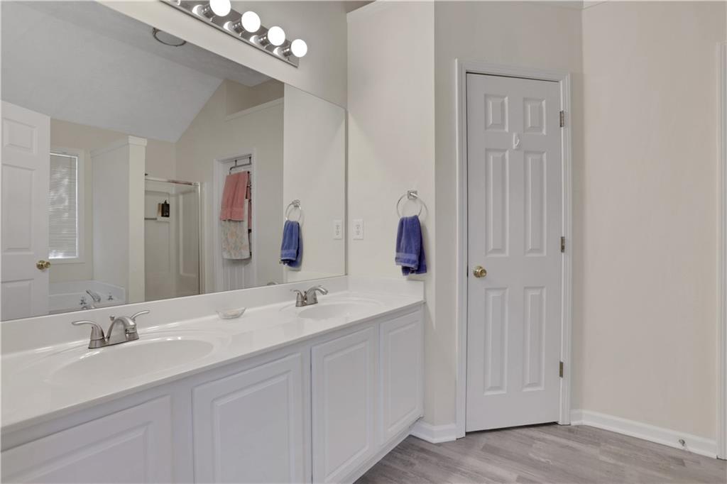 2760 Jona Trail Dacula, GA 30019 - Photo 23 of 40 a bathroom with a double vanity sink and a mirror