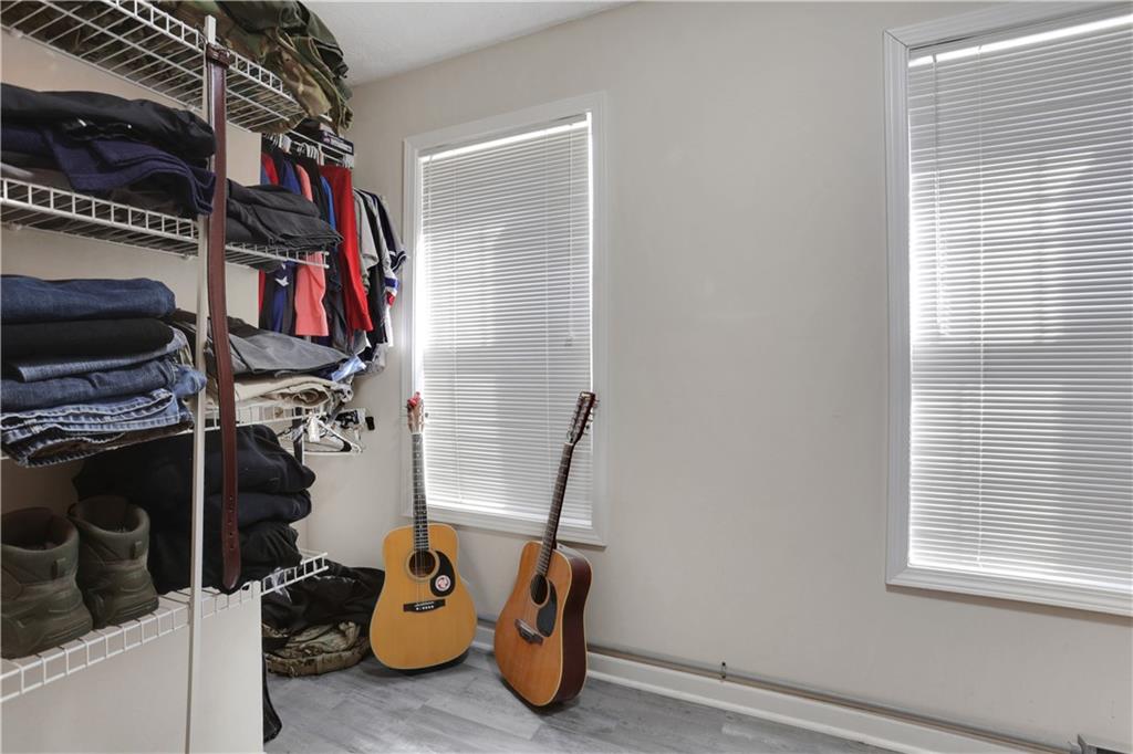 2760 Jona Trail Dacula, GA 30019 - Photo 26 of 40 a view of walk in closet with clothes and shoes