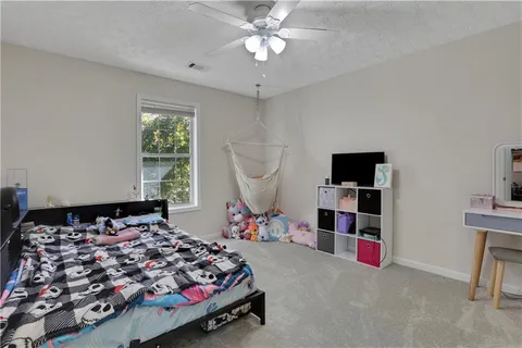 a bedroom with bed and a chandelier