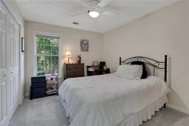 a bedroom with bed and window