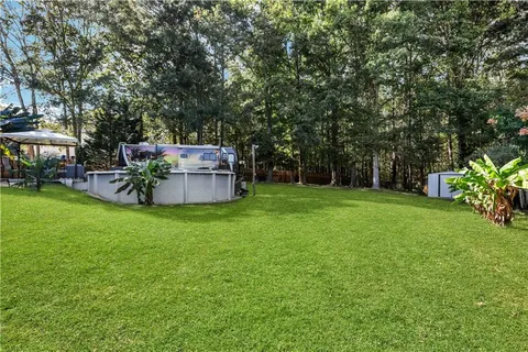 a view of a backyard with a garden and trees