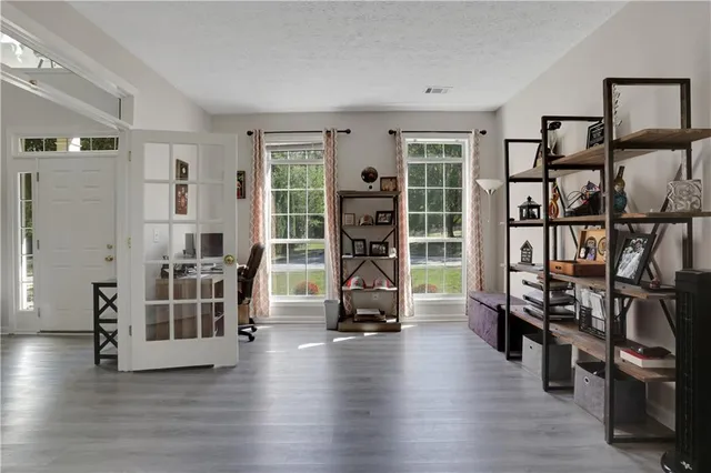 a view of a livingroom with furniture and an empty room