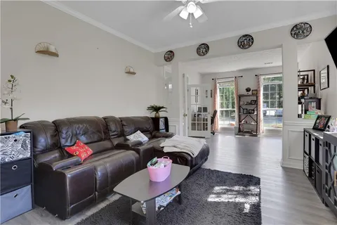 a living room with furniture and wooden floor