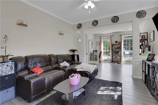 a living room with furniture and wooden floor