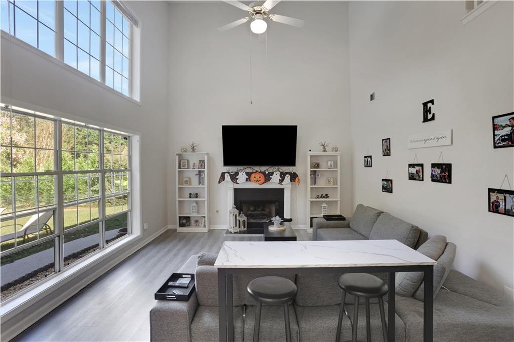 2760 Jona Trail Dacula, GA 30019 - Photo 8 of 40 a living room with furniture a flat screen tv and a large window