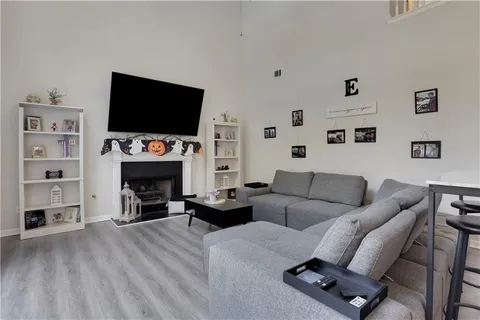 a living room with furniture a flat screen tv and a fireplace