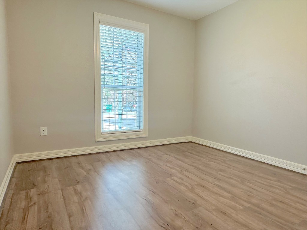 25827 Water Ridge Drive Huffman, TX 77336 - Photo 13 of 22 wooden floor in an empty room with a window