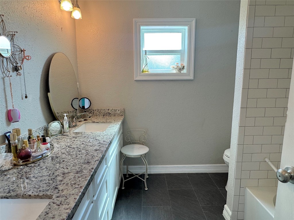 25827 Water Ridge Drive Huffman, TX 77336 - Photo 14 of 22 a bathroom with a granite countertop sink and a mirror