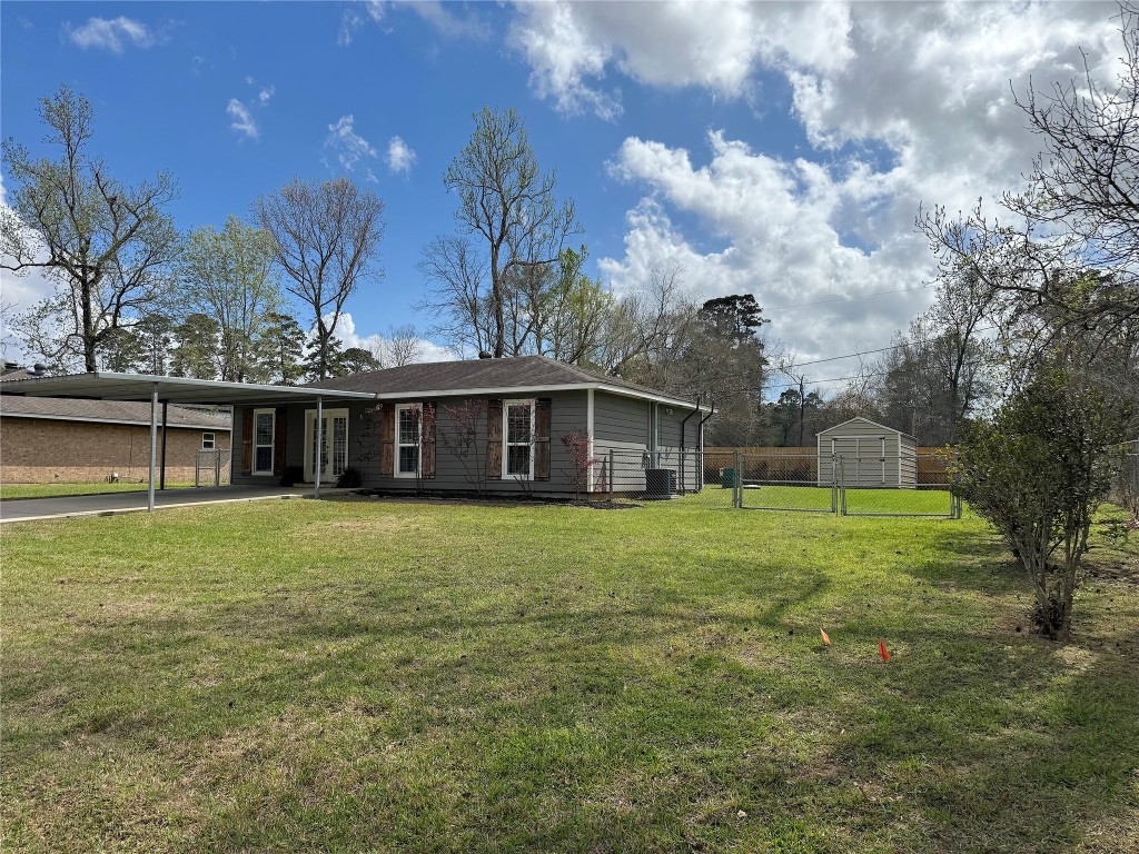 25827 Water Ridge Drive Huffman, TX 77336 - Photo 16 of 22 a front view of a house with a garden