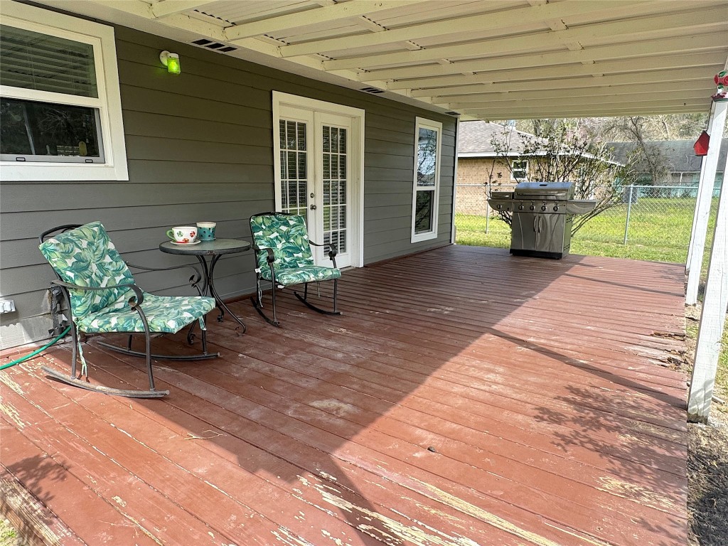 25827 Water Ridge Drive Huffman, TX 77336 - Photo 17 of 22 a view of a patio with table and chairs and potted plants