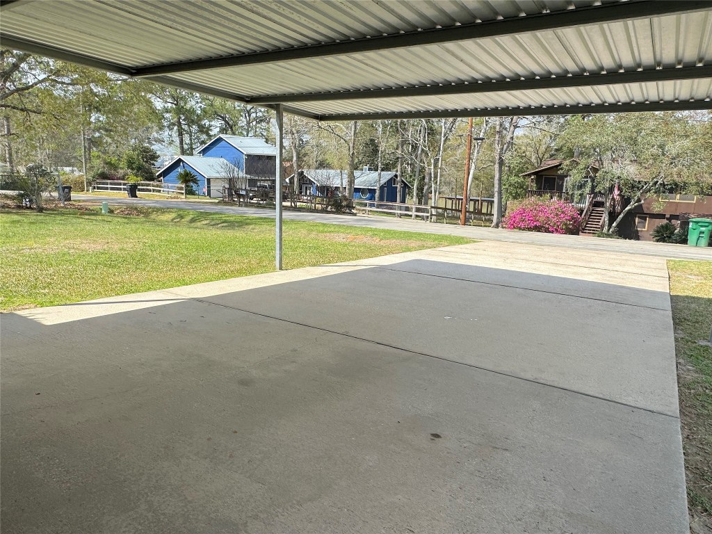 25827 Water Ridge Drive Huffman, TX 77336 - Photo 21 of 22 a view of swimming pool with lawn chairs and floor to ceiling window and a yard