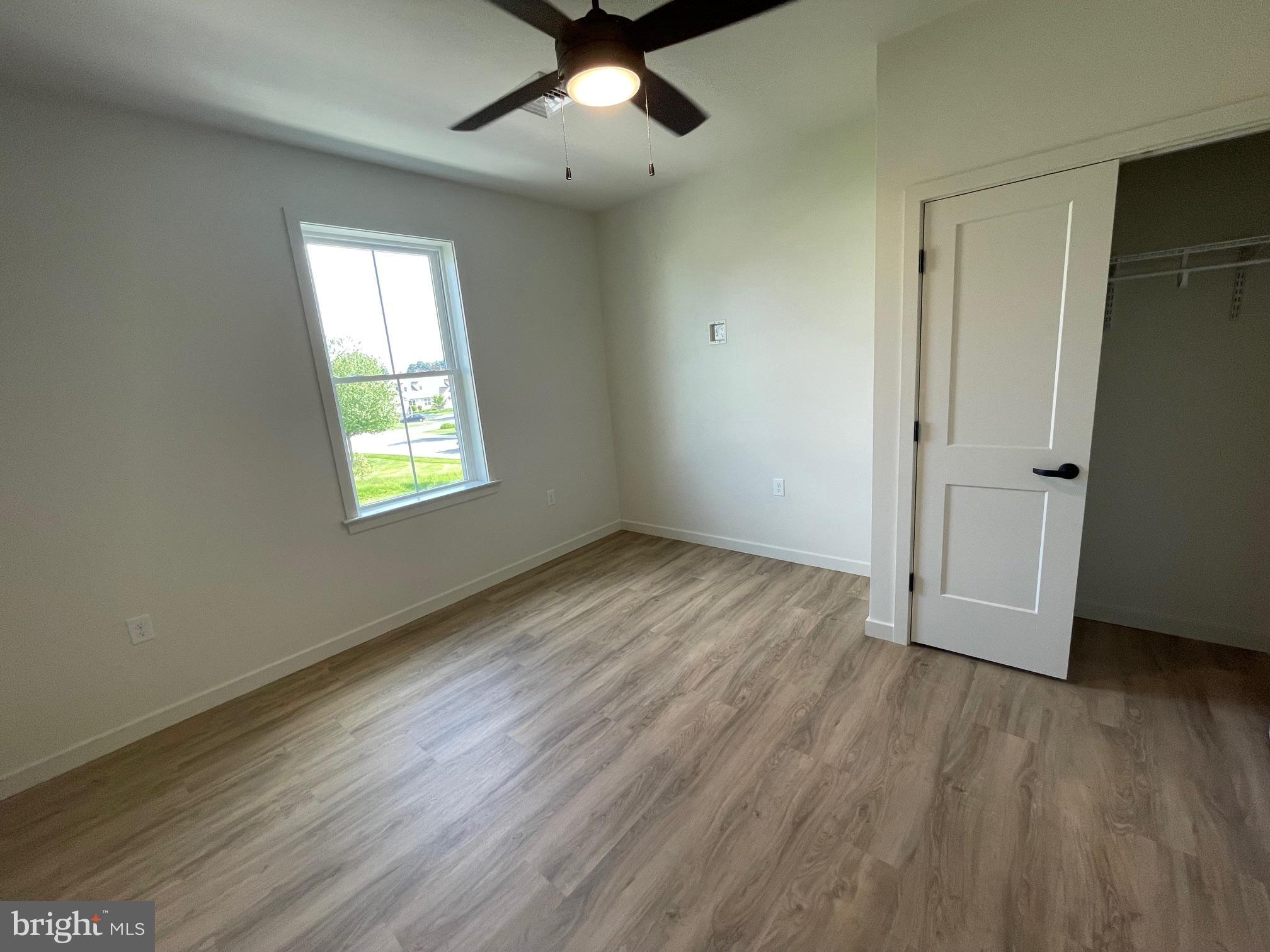 15 Kennedy Street Lancaster, PA 17602 - Photo 11 of 17 an empty room with wooden floor ceiling fan and windows