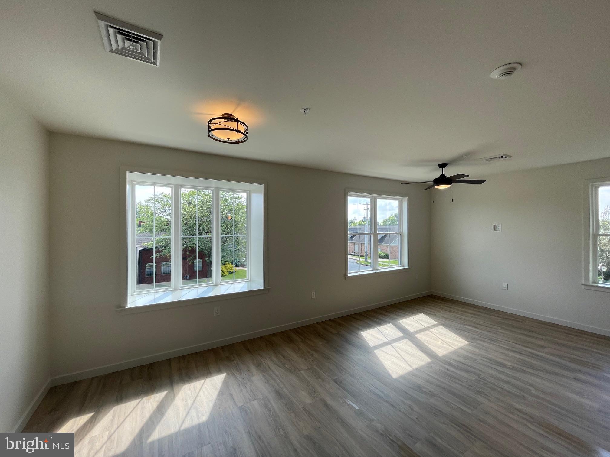 15 Kennedy Street Lancaster, PA 17602 - Photo 15 of 17 an empty room with wooden floor and windows