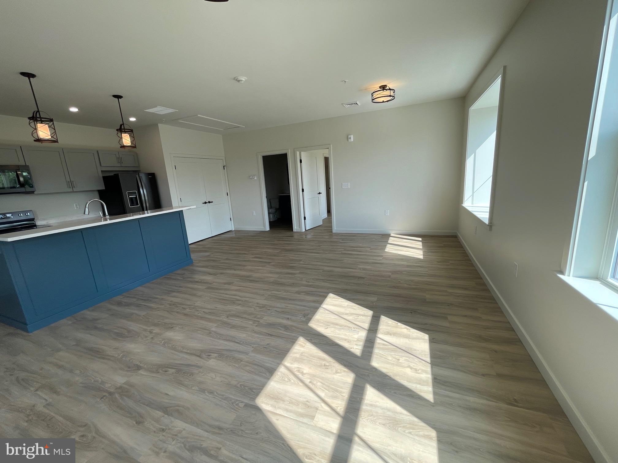 15 Kennedy Street Lancaster, PA 17602 - Photo 4 of 17 a large kitchen with kitchen island a sink wooden floor and a large window