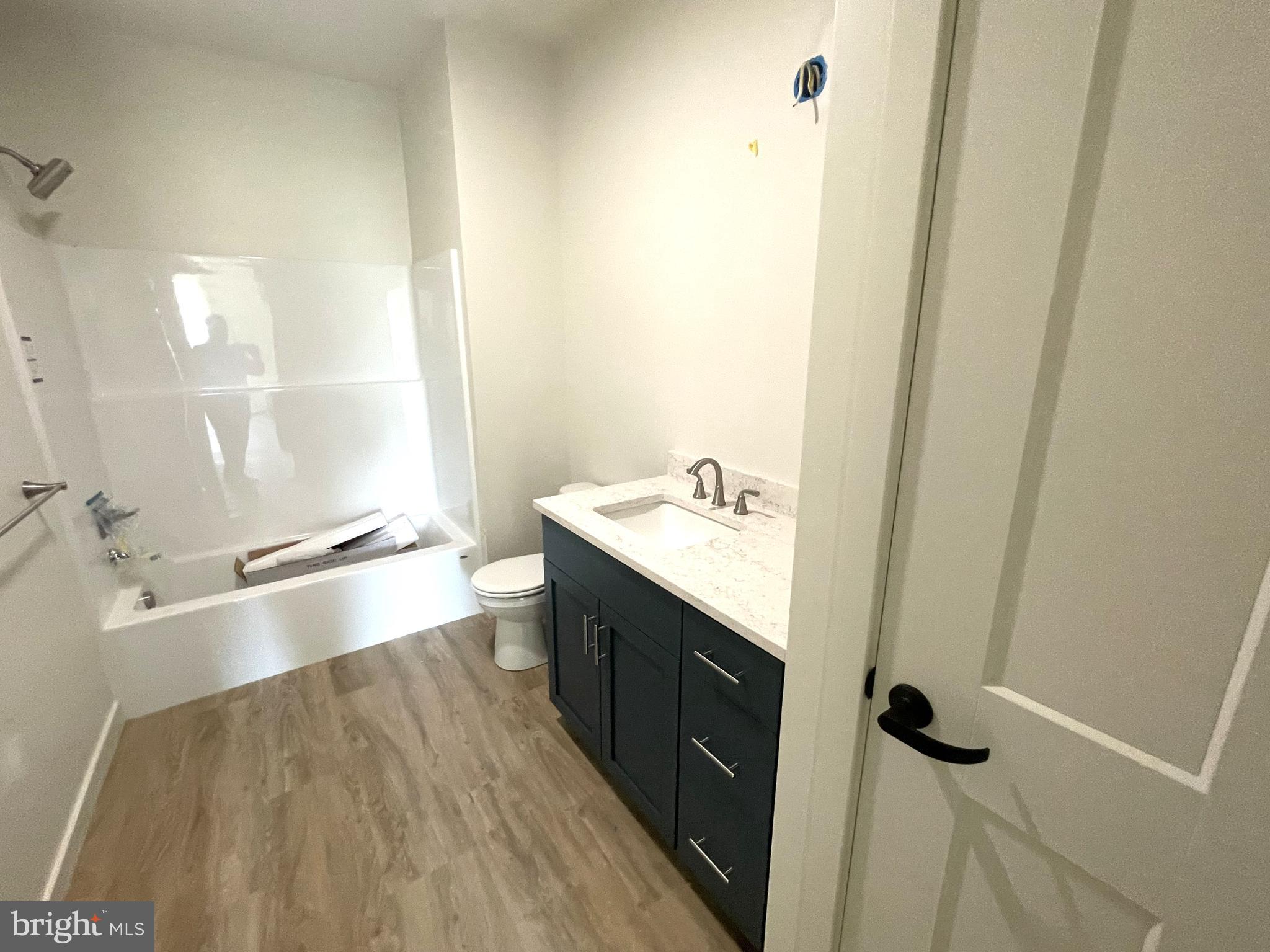 15 Kennedy Street Lancaster, PA 17602 - Photo 8 of 17 a bathroom with a granite countertop sink a toilet and shower