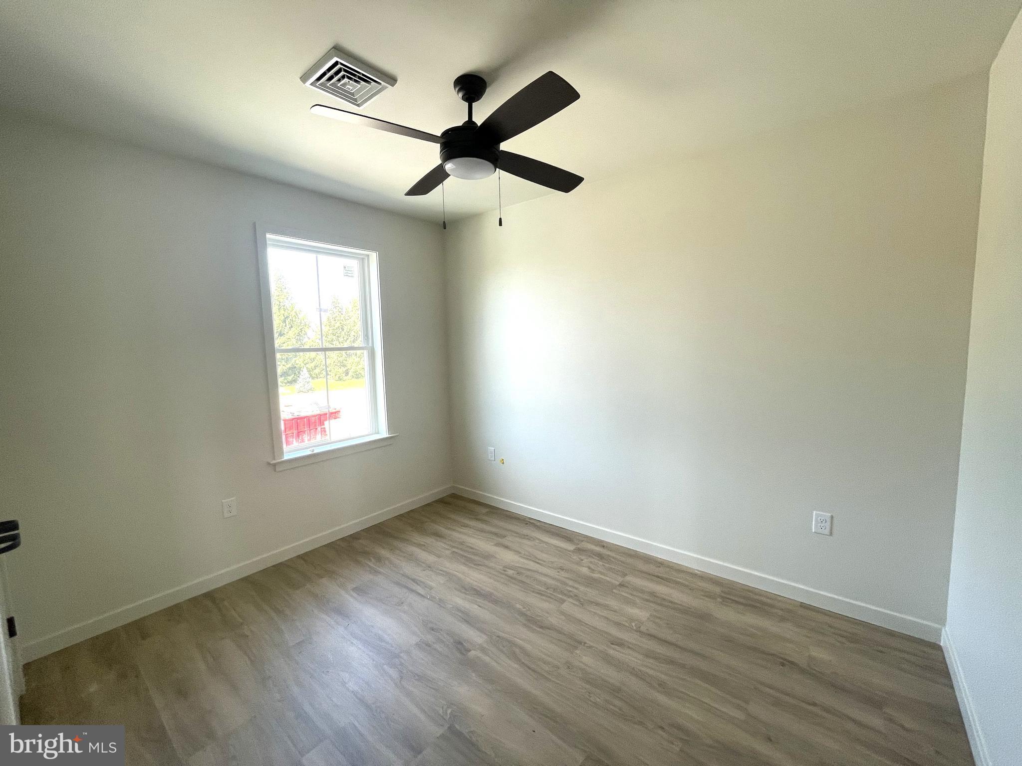 15 Kennedy Street Lancaster, PA 17602 - Photo 9 of 17 an empty room with wooden floor ceiling fan and windows