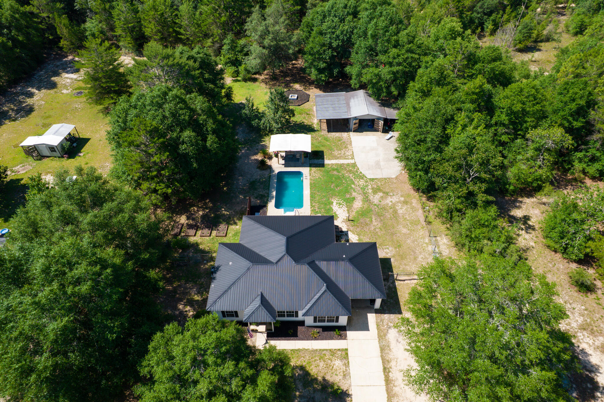 4236 Edge Perry Road Crestview, FL 32539 - Photo 1 of 51 an aerial view of a house with a yard and large trees