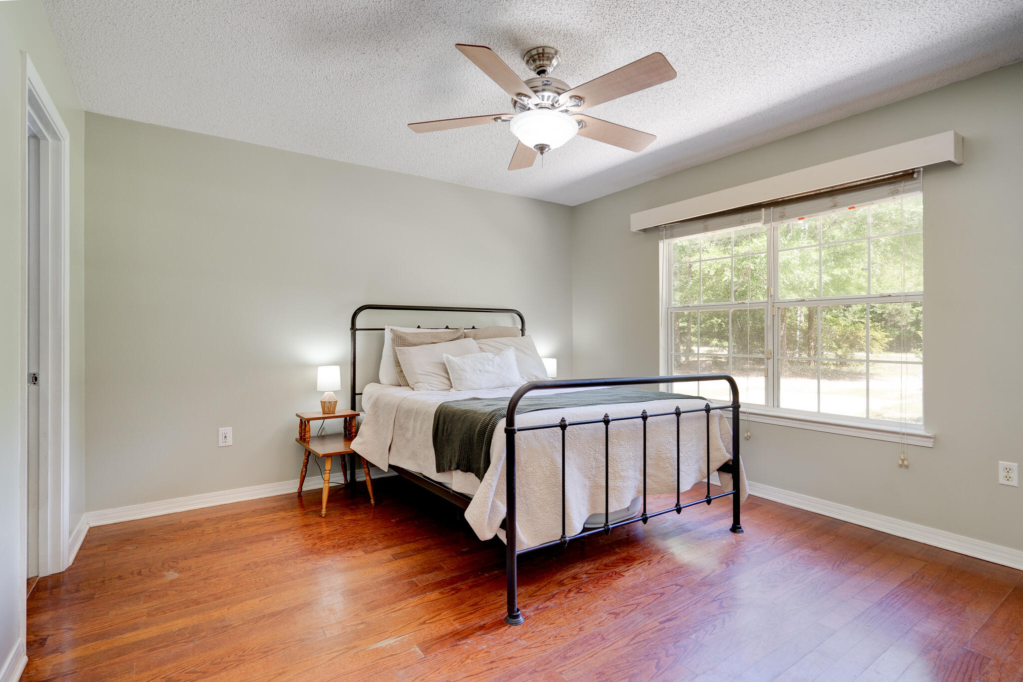 4236 Edge Perry Road Crestview, FL 32539 - Photo 13 of 51 a bedroom with a bed next to a window with a chandelier