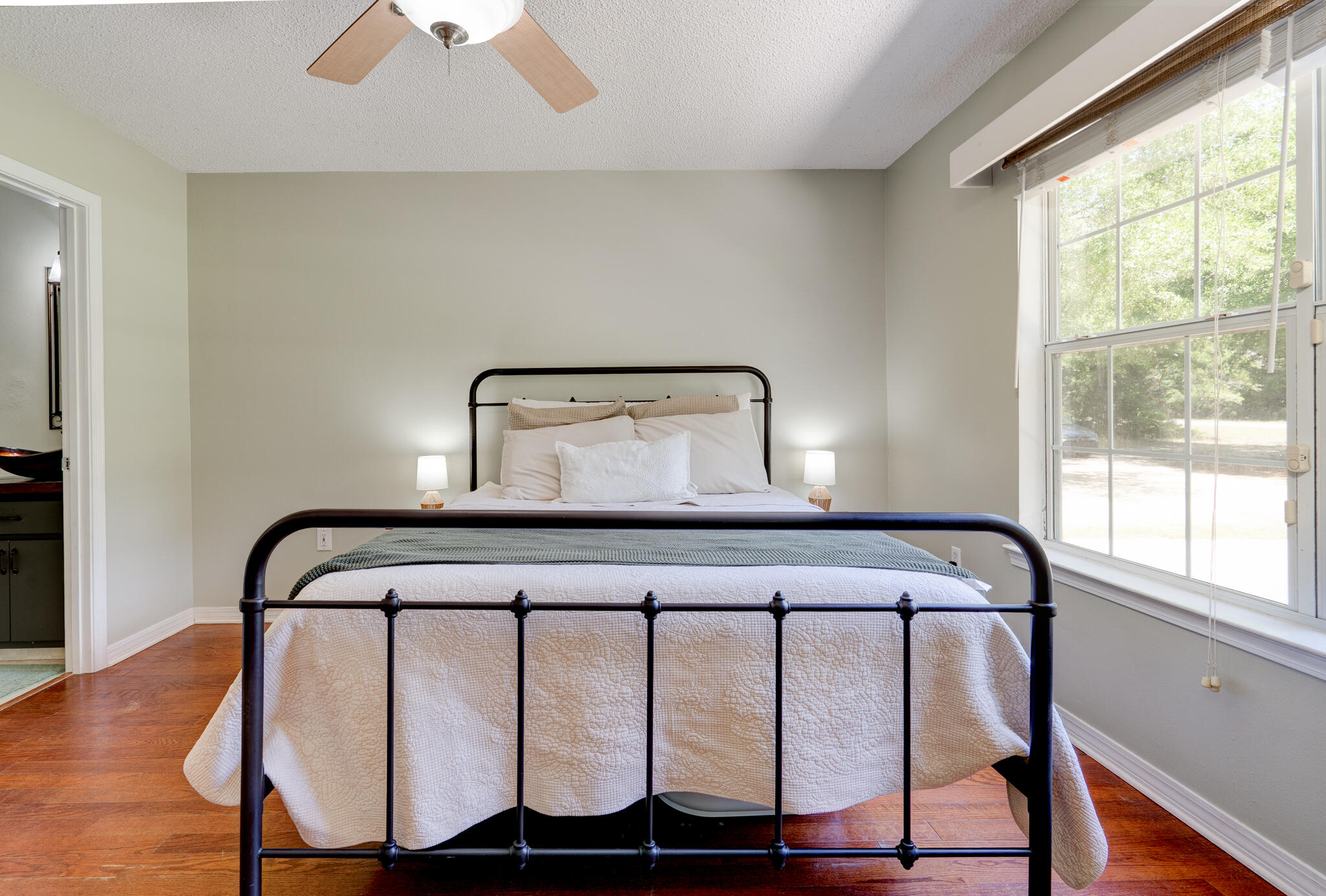 4236 Edge Perry Road Crestview, FL 32539 - Photo 14 of 51 a bedroom with a bed and wooden floor