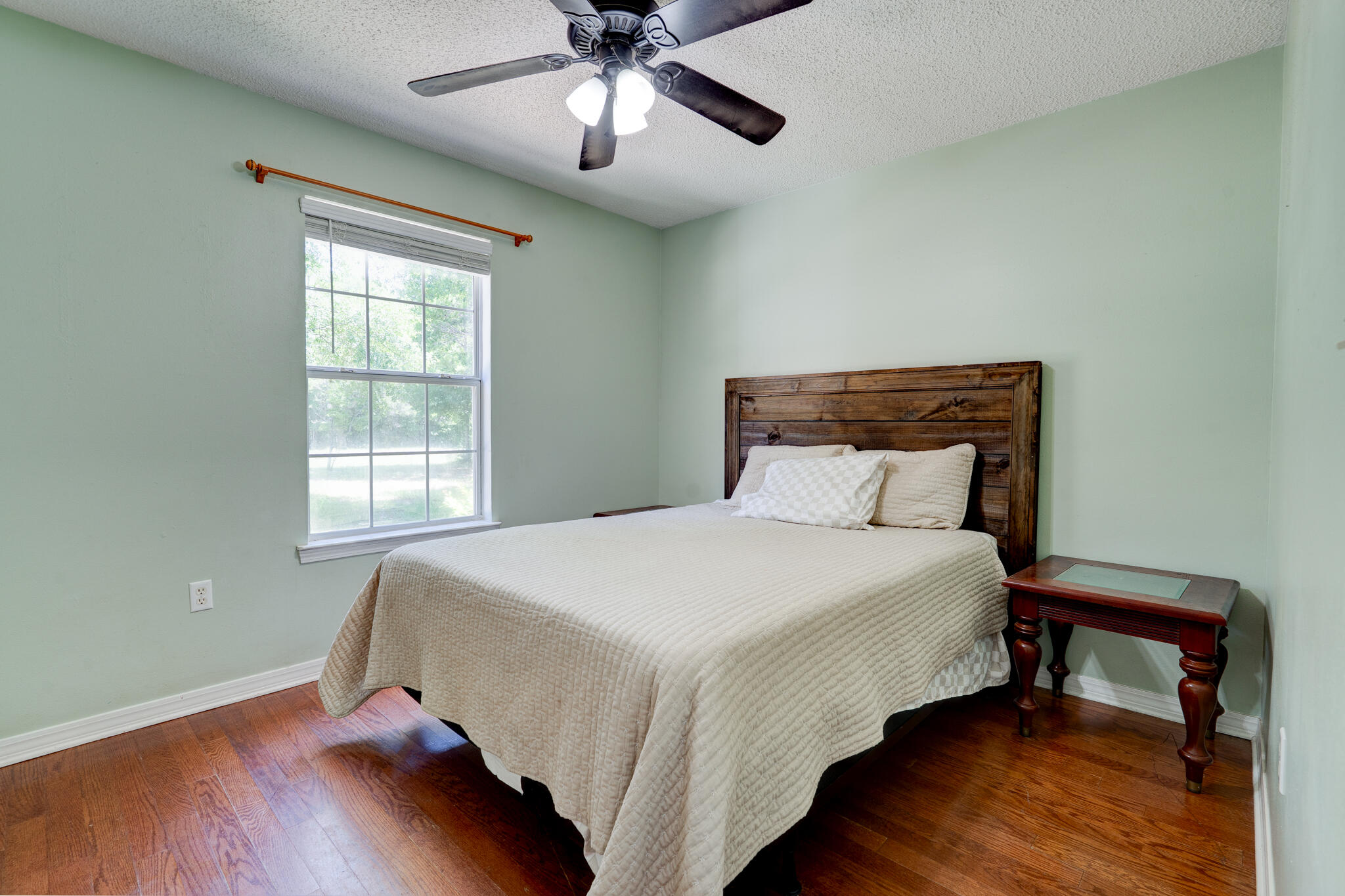 4236 Edge Perry Road Crestview, FL 32539 - Photo 19 of 51 a bed sitting in a bedroom next to a window