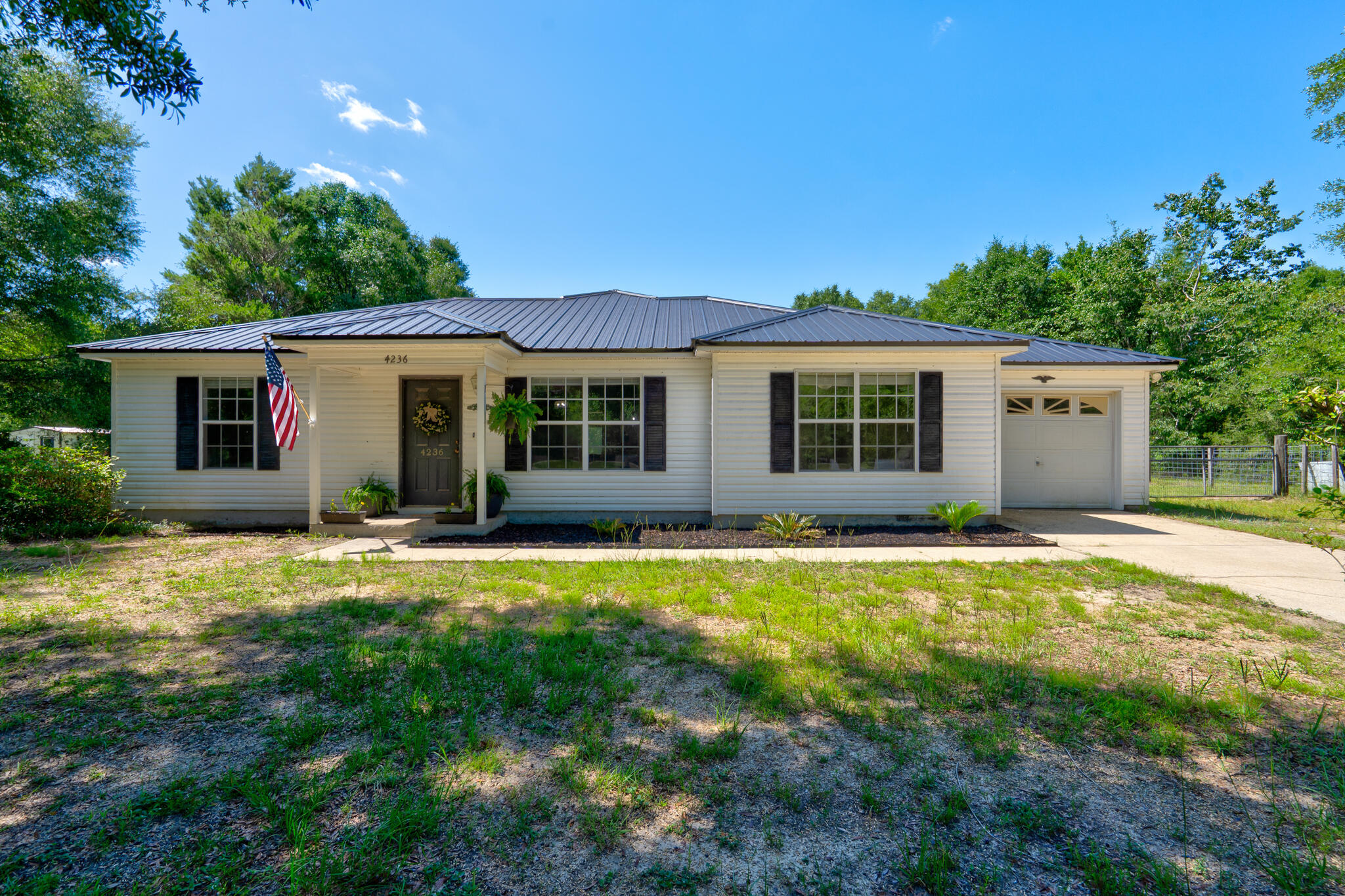 4236 Edge Perry Road Crestview, FL 32539 - Photo 2 of 51 a swimming pool with outdoor seating and yard