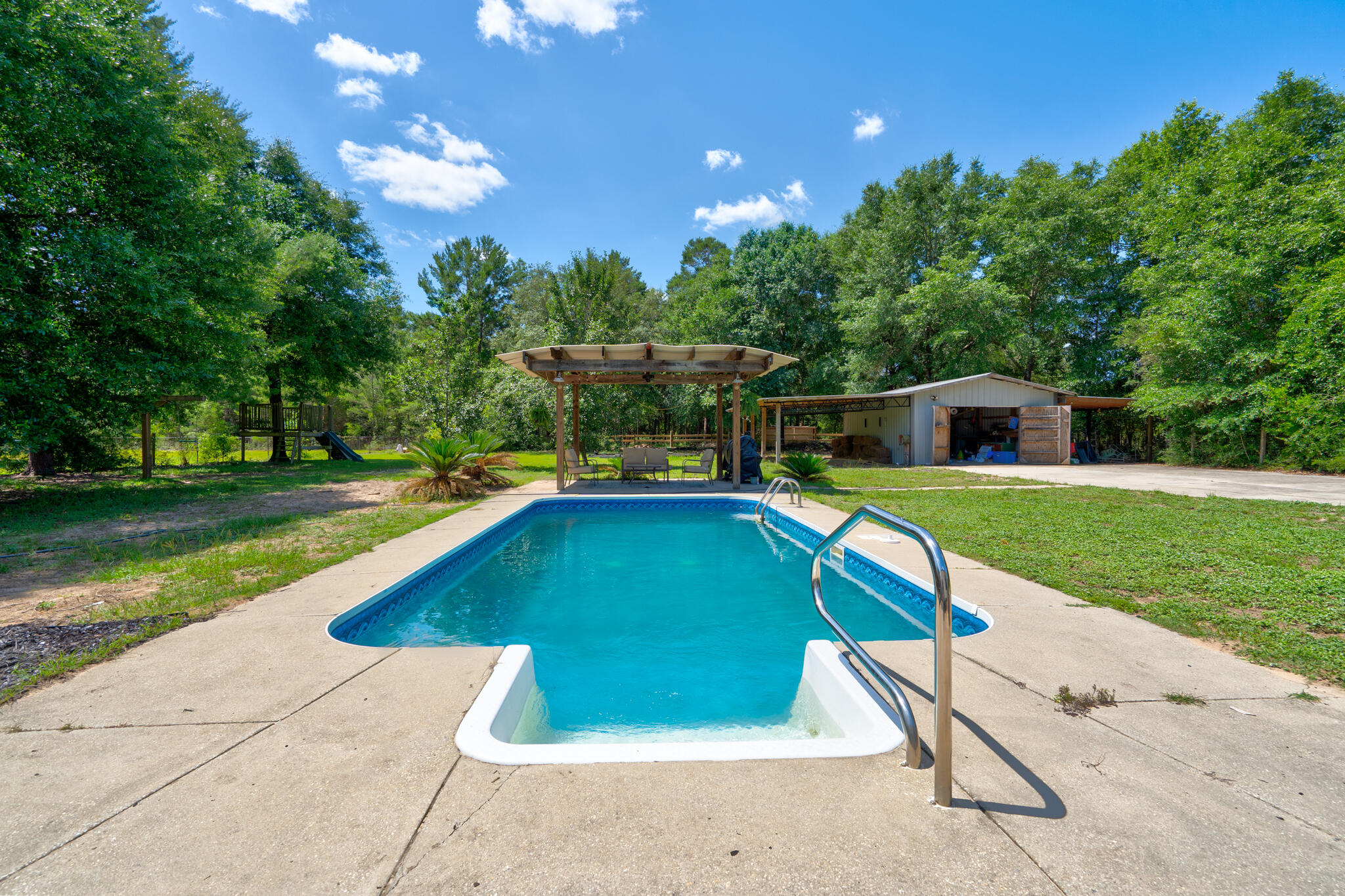 4236 Edge Perry Road Crestview, FL 32539 - Photo 21 of 51 a swimming pool with outdoor seating and yard