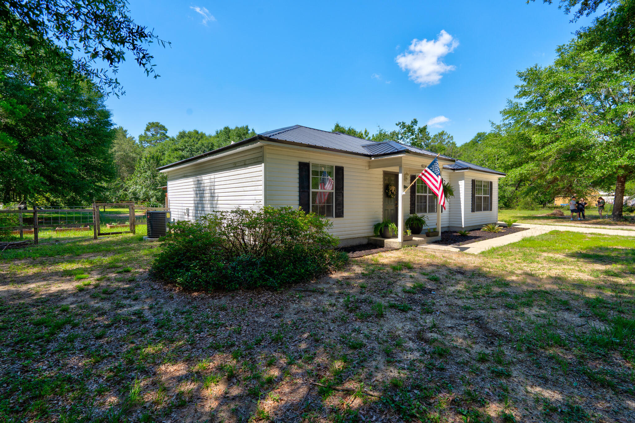 4236 Edge Perry Road Crestview, FL 32539 - Photo 36 of 51 a view of a house with backyard and a garden