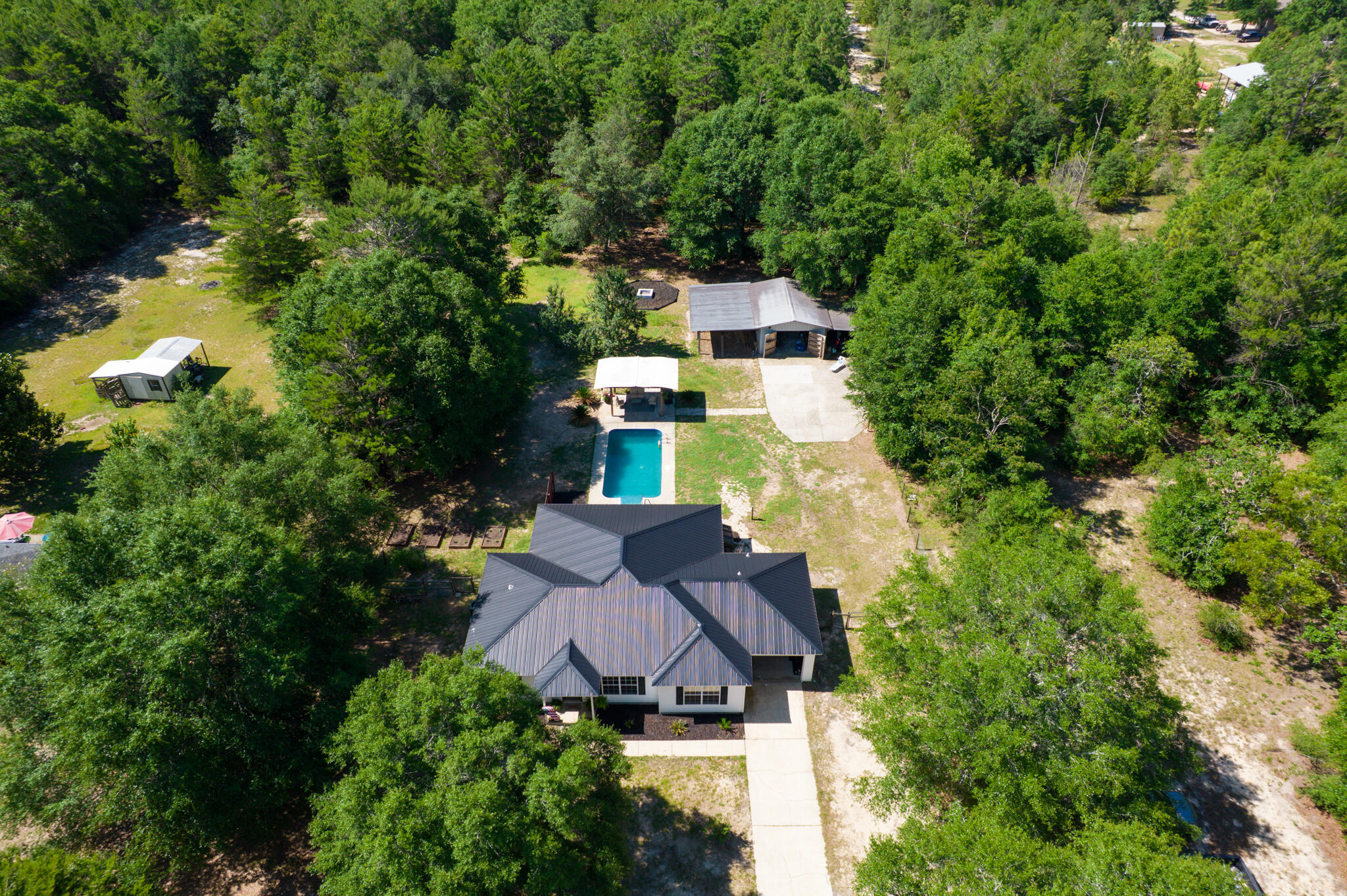 4236 Edge Perry Road Crestview, FL 32539 - Photo 37 of 51 an aerial view of a house with swimming pool a yard and trees