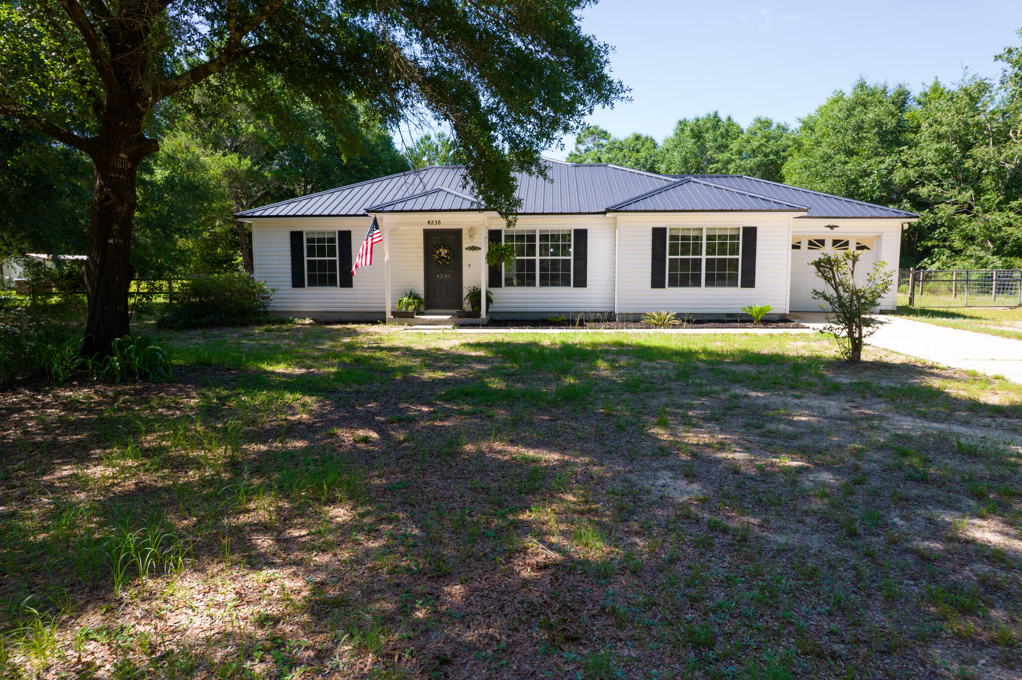 4236 Edge Perry Road Crestview, FL 32539 - Photo 49 of 51 a front view of a house with a garden
