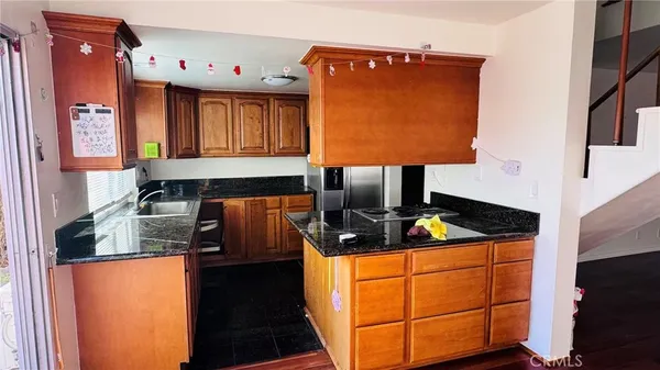 a kitchen with stainless steel appliances granite countertop a sink stove and cabinets