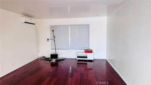 a room with wooden floor and shoes