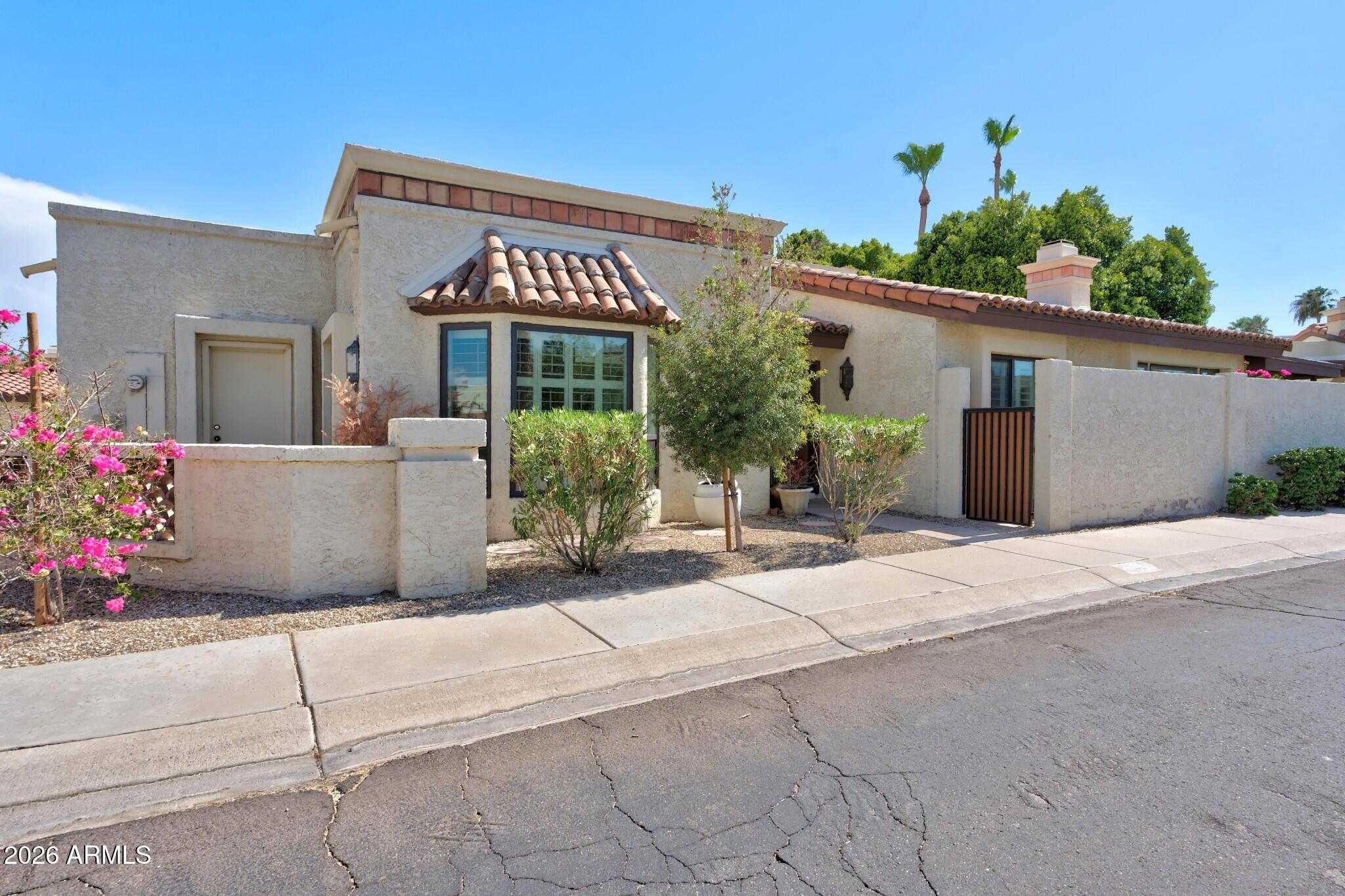 4615 East Monte Way Phoenix, AZ 85044 - Photo 2 of 35 a front view of a house with a yard and potted plants