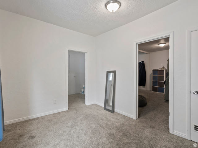 510 Canyon Road Ogden, UT 84404 - Photo 9 of 30 Unfurnished bedroom featuring light colored carpet and a textured ceiling