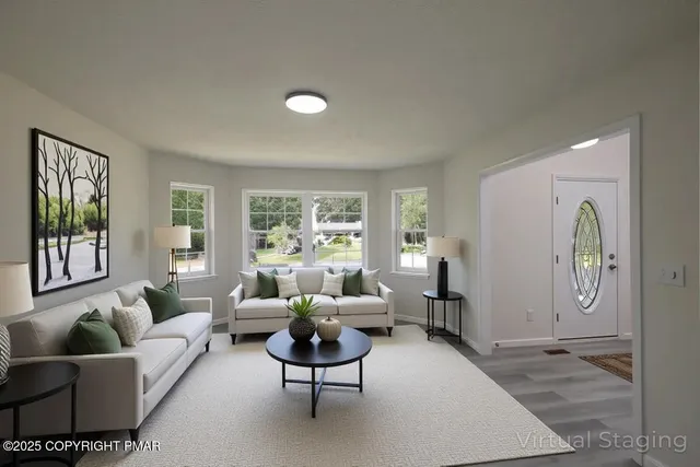 an empty room with chandelier fan and windows