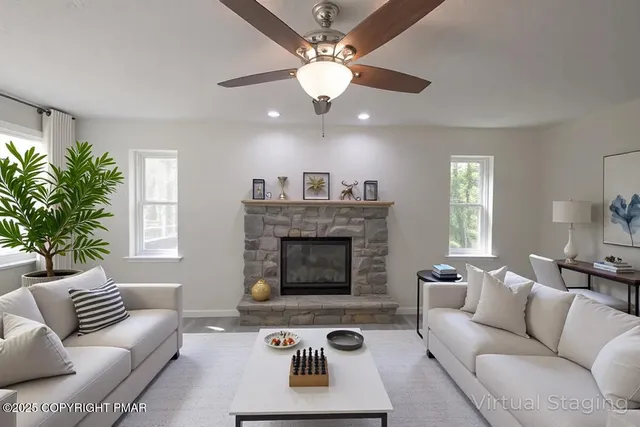 an empty room with windows and fireplace