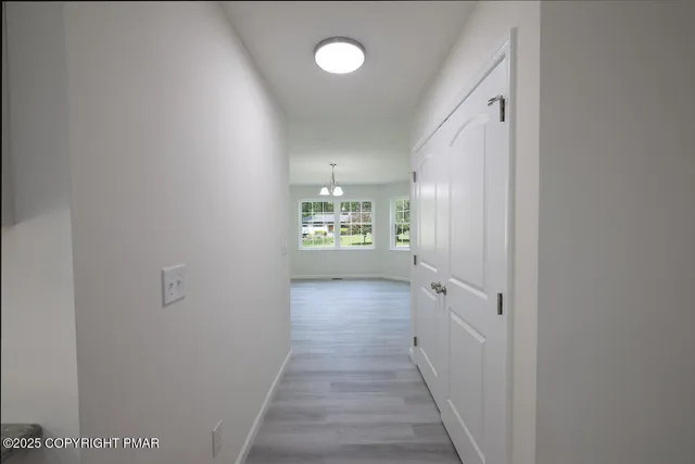 a kitchen with a refrigerator a sink and dishwasher a oven with wooden floor