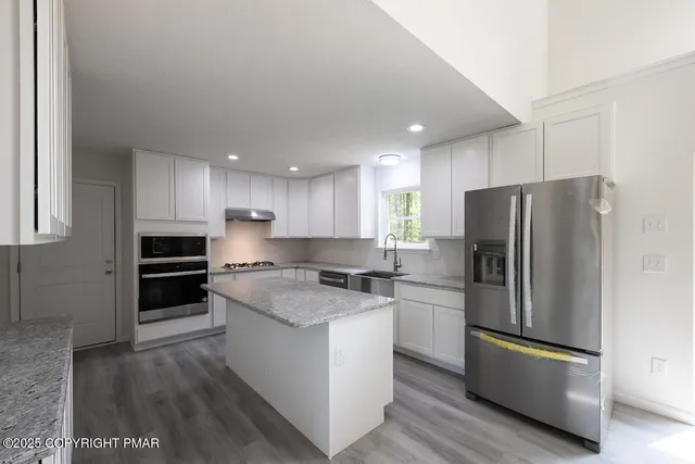 a kitchen with a sink and a refrigerator